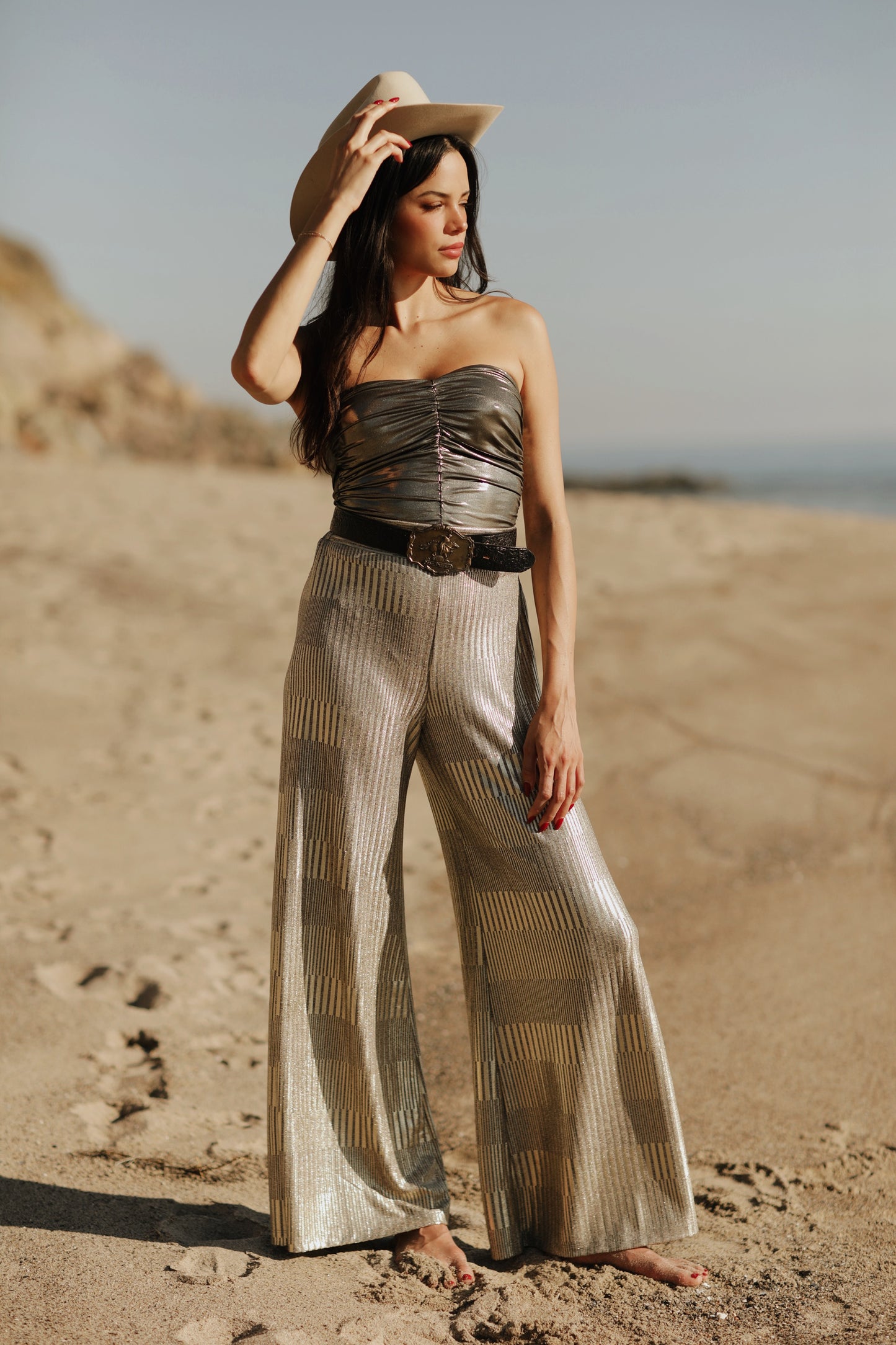 Designed to captivate, our stylish Ruched Metallic Tube Top is the perfect piece to sparkle in on date night. Crafted from a metallic Lamé fabric that shines in the light, it features delicate ruching that creates a figure-flattering silhouette. An easy and sexy piece, it's a must-have for any party occasion. Style Back to our Wide Leg Lamé pants to complete the look.