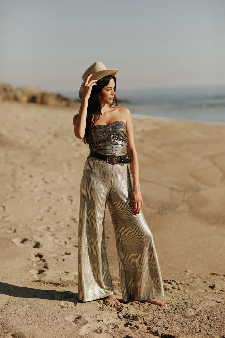 Designed to captivate, our stylish Ruched Metallic Tube Top is the perfect piece to sparkle in on date night. Crafted from a metallic Lamé fabric that shines in the light, it features delicate ruching that creates a figure-flattering silhouette. An easy and sexy piece, it&
