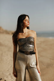 Designed to captivate, our stylish Ruched Metallic Tube Top is the perfect piece to sparkle in on date night. Crafted from a metallic Lamé fabric that shines in the light, it features delicate ruching that creates a figure-flattering silhouette. An easy and sexy piece, it's a must-have for any party occasion. Style Back to our Wide Leg Lamé pants to complete the look.