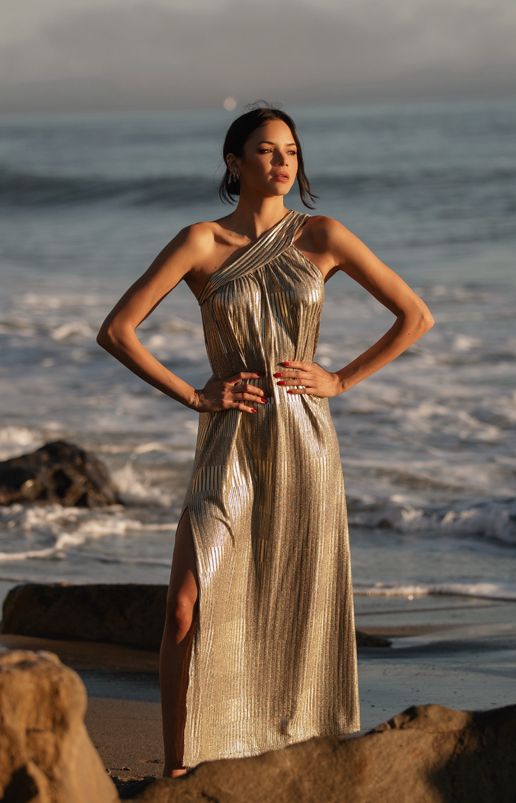 Sparkle in this stunning Grecian Lamé One Shoulder Gown. Crafted from luxurious lamé Viscose fabric, this flowey and luminous gown is perfect for any special occasion. Featuring a side slit and one shoulder design, you&