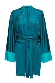 Experience the sophisticated elegance of the Kimono Mini Dress. Its luxuriously silky fabric and tie-wrap style create a timeless silhouette perfect for any getaway or night out. With its low neckline, large kimono sleeves this sleek and sexy dress will ensure you make a glamorous statement. Our Aquamarine is a vibrant color that lights up your complexion. Glow in this stunning mini dress to a dressy event or a poolside cocktail look.