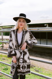 Designed with chic coastal cowgirl vibes, the Aztec Trench Wrap Coat by Gone With The West is the perfect way to stay cozy and warm this winter. Crafted from a luxurious wool and cashmere blend, this wrap coat brings sophisticated exclusivity to any ensemble.