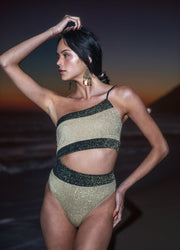 Experience the elegance of this shimmering Disco One Shoulder Swimsuit for a party on the beach or by the pool. Crafted with Lurex fabric and contrast bands, this Asymmetrical cutout swimsuit will make you shine in the sun for a dressy beach look or more relaxed poolside party. Pre order now to get your Disco on!
