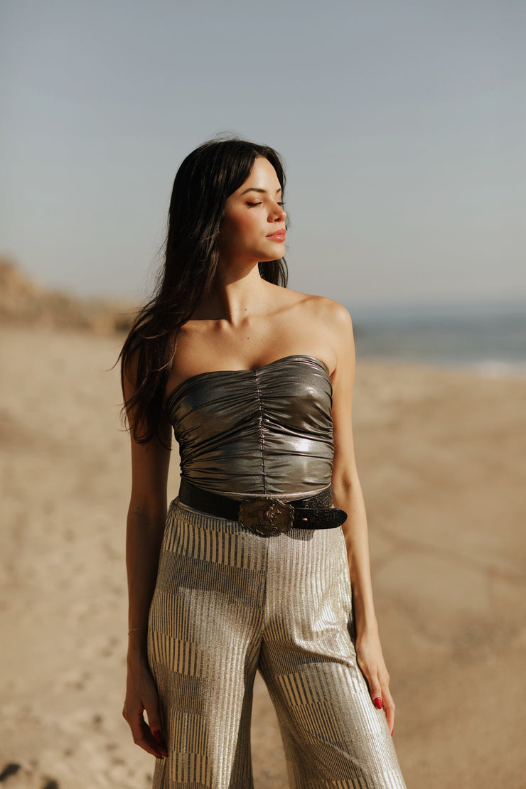 Designed to captivate, our stylish Ruched Metallic Tube Top is the perfect piece to sparkle in on date night. Crafted from a metallic Lamé fabric that shines in the light, it features delicate ruching that creates a figure-flattering silhouette. An easy and sexy piece, it&
