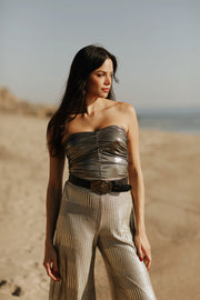 Designed to captivate, our stylish Ruched Metallic Tube Top is the perfect piece to sparkle in on date night. Crafted from a metallic Lamé fabric that shines in the light, it features delicate ruching that creates a figure-flattering silhouette. An easy and sexy piece, it's a must-have for any party occasion. Style Back to our Wide Leg Lamé pants to complete the look.
