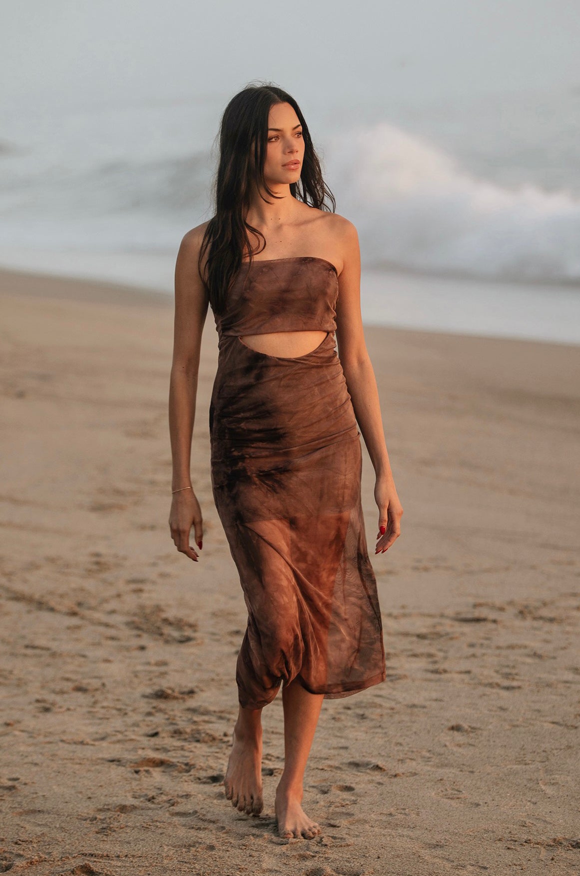 Look no further than the Mocha Tie Dye Mesh Tube Dress to make a timelessly chic statement. Exuding sophistication, this elegant piece is crafted with comfy, full stretch mesh, creating a beautiful silhouette that is perfect for a variety of occasions. From beachy vacation vibes to a dressy date night, this dress has you covered. 