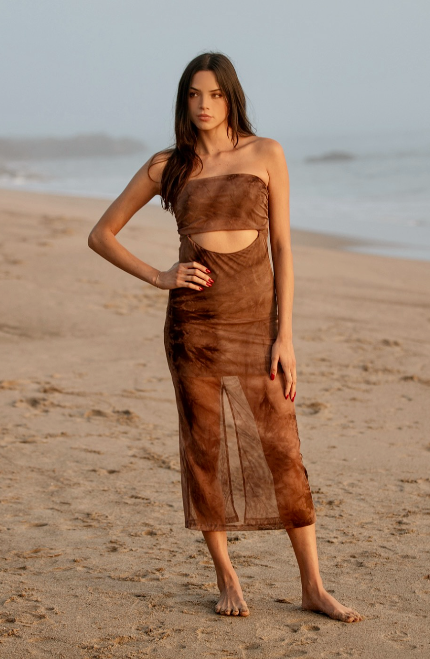 Look no further than the Mocha Tie Dye Mesh Tube Dress to make a timelessly chic statement. Exuding sophistication, this elegant piece is crafted with comfy, full stretch mesh, creating a beautiful silhouette that is perfect for a variety of occasions. From beachy vacation vibes to a dressy date night, this dress has you covered. 